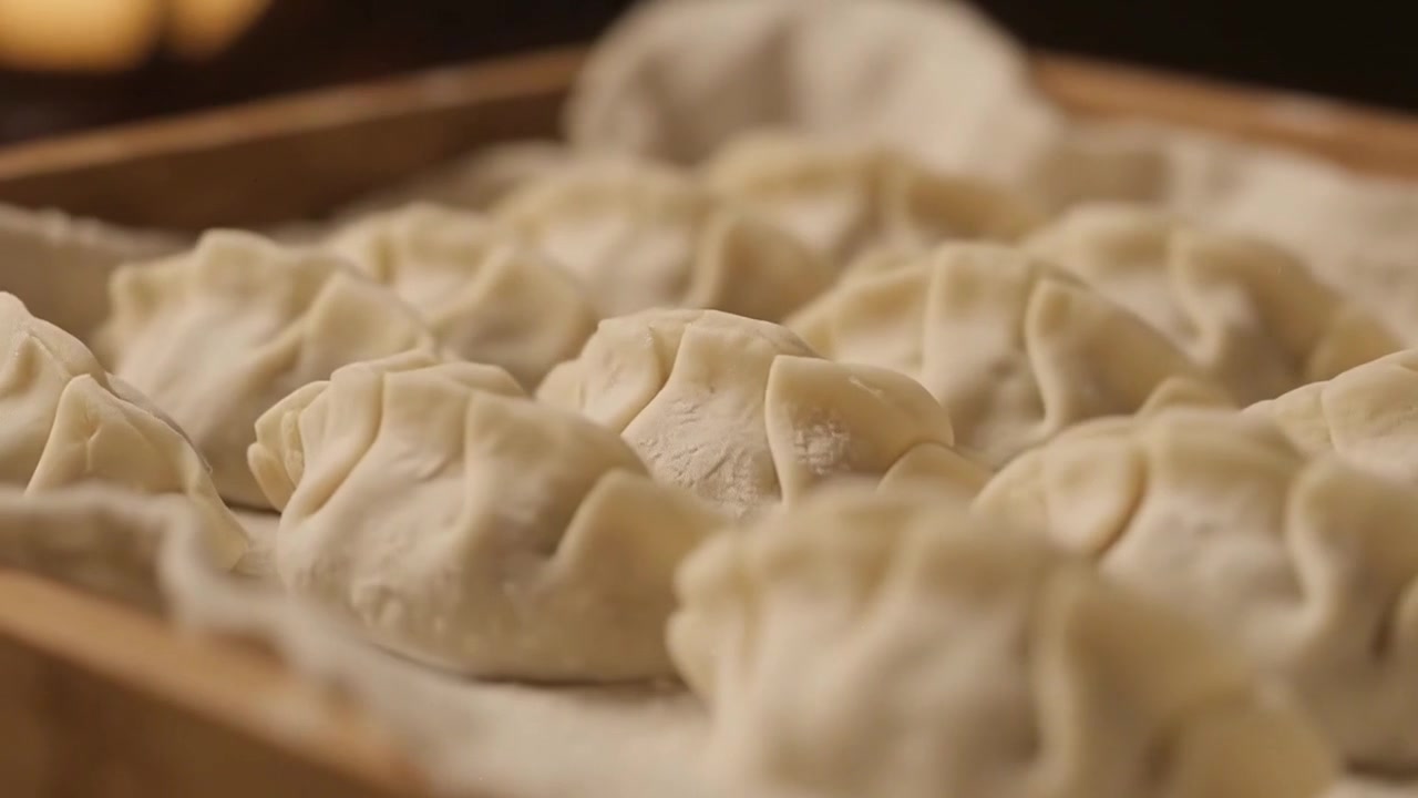 Mature Asian Woman Making Homemade Dumplings in Kitchen