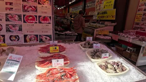 various seafood displayed at a busy market