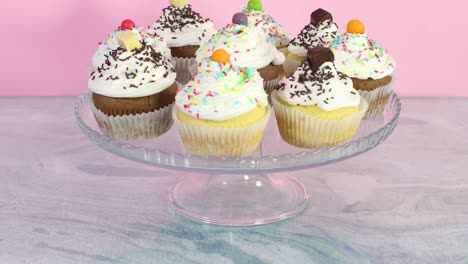 sweet cup cakes with cream served on crystal plate for the party