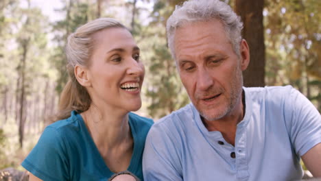 Couple-using-map-and-compass-to-find-the-way