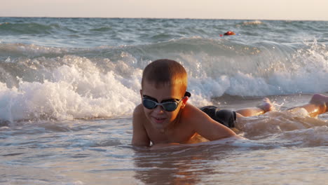 child is excited with sea waves covering him