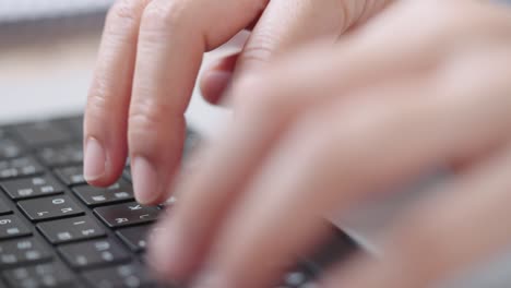 close up shot of businesswoman hands typing on laptop computer keyboard for searching information,online communication support,marketing research,business report in the office desk at night.