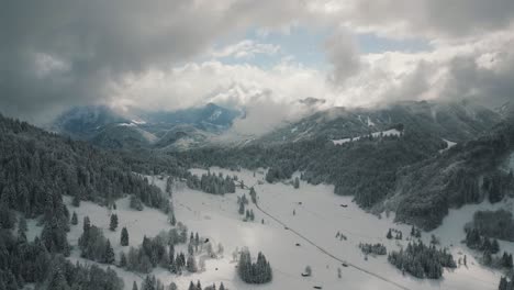 Mountain-valley-snowy-landscape-with-snow,-sunlight-and-blue-sky