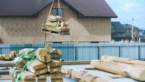 log house construction with crane