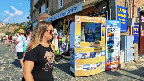 visitors browse shops and enjoy the sunny harbor