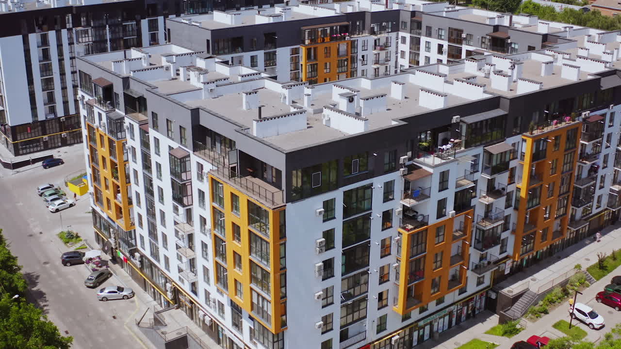 Modern residential building. Beautiful design of a new city complex. High-rise apartment buildings with windows and balconies. Aerial view.