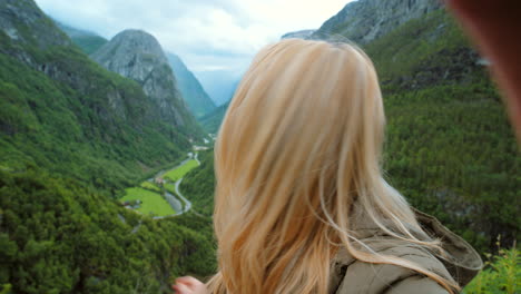 woman waving and kissing at norwegian fjords