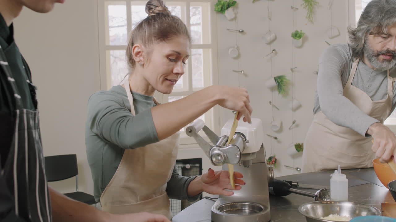 People cooking pasta in the kitchen