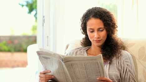 young woman reading a newspaper