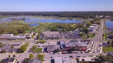 panning aerial of streets and wetlands in town of montague, michigan