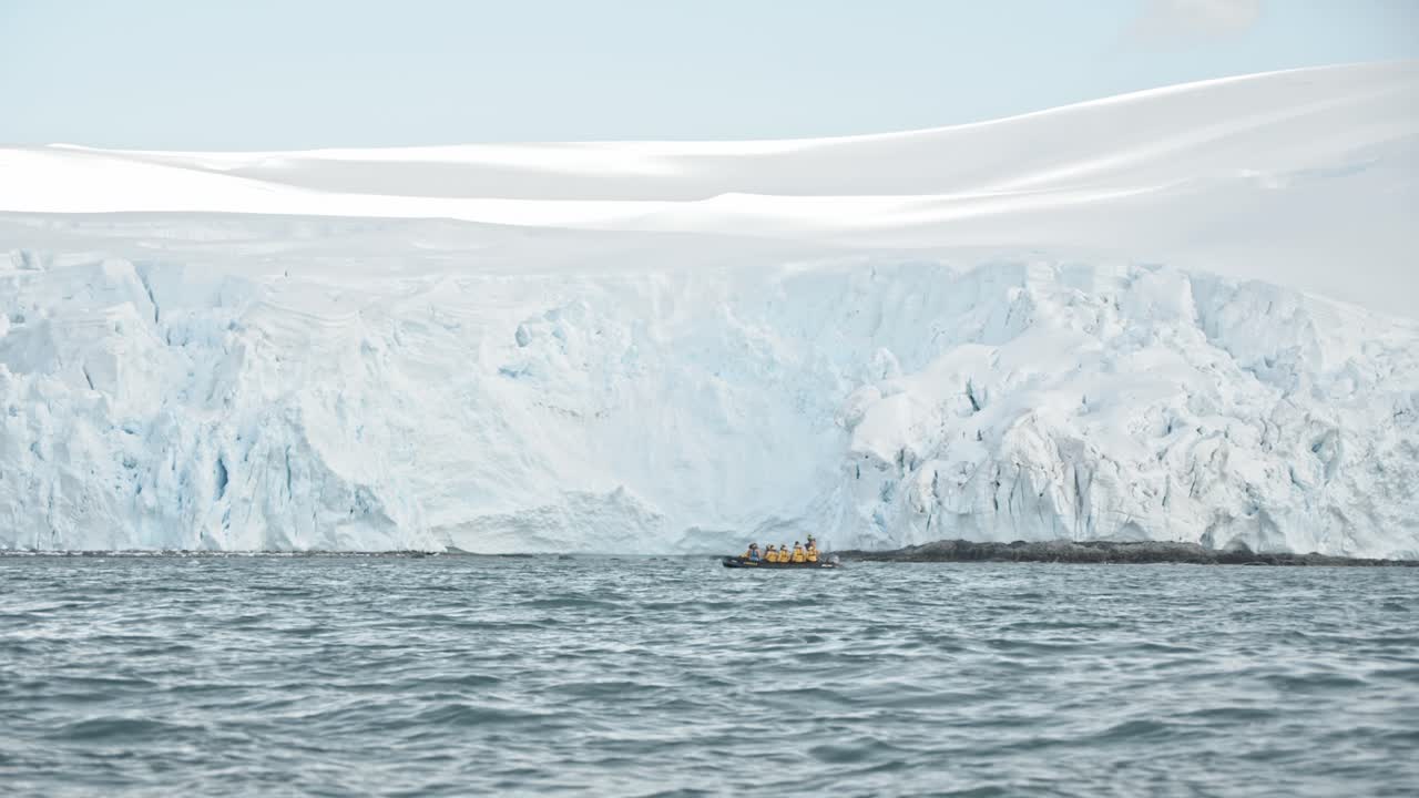남극 투어 중 큰 빙하 앞에서 항해하는 관광객들과의 조디악