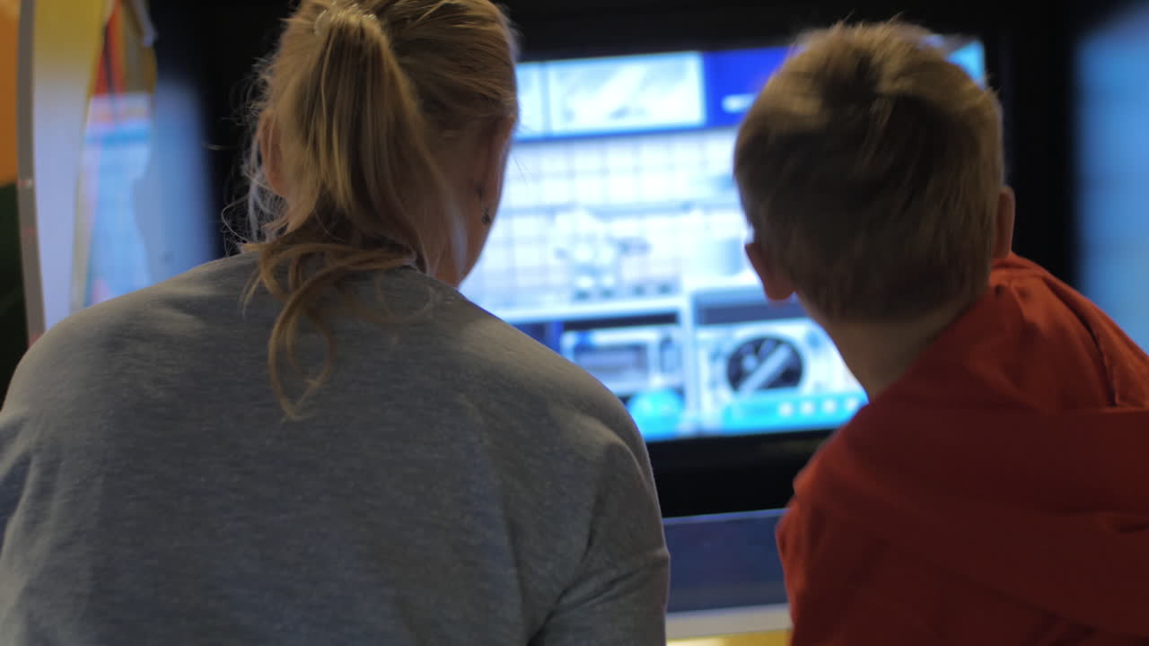 madre y hijo divirtiéndose con la máquina de diversión