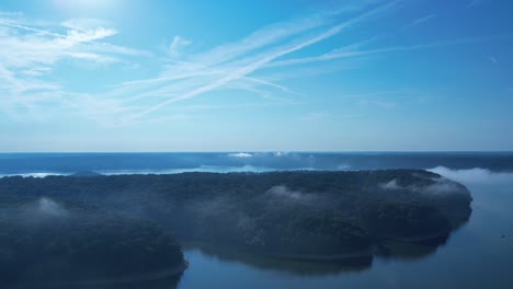 Time-lapse-of-clouds-passing-through-the-trees-lining-the-shore-of-Lake-Monroe