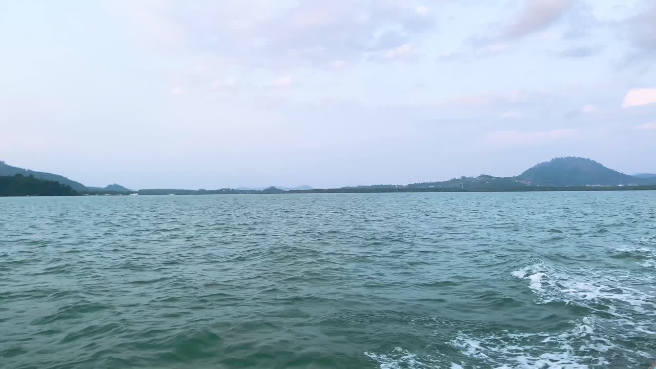 Landscape view of the sea ocean in early morning with sunrise in summer daytime while on the moving boat