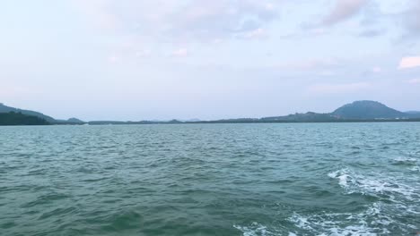 landscape view of the sea ocean in early morning with sunrise in summer daytime while on the moving boat