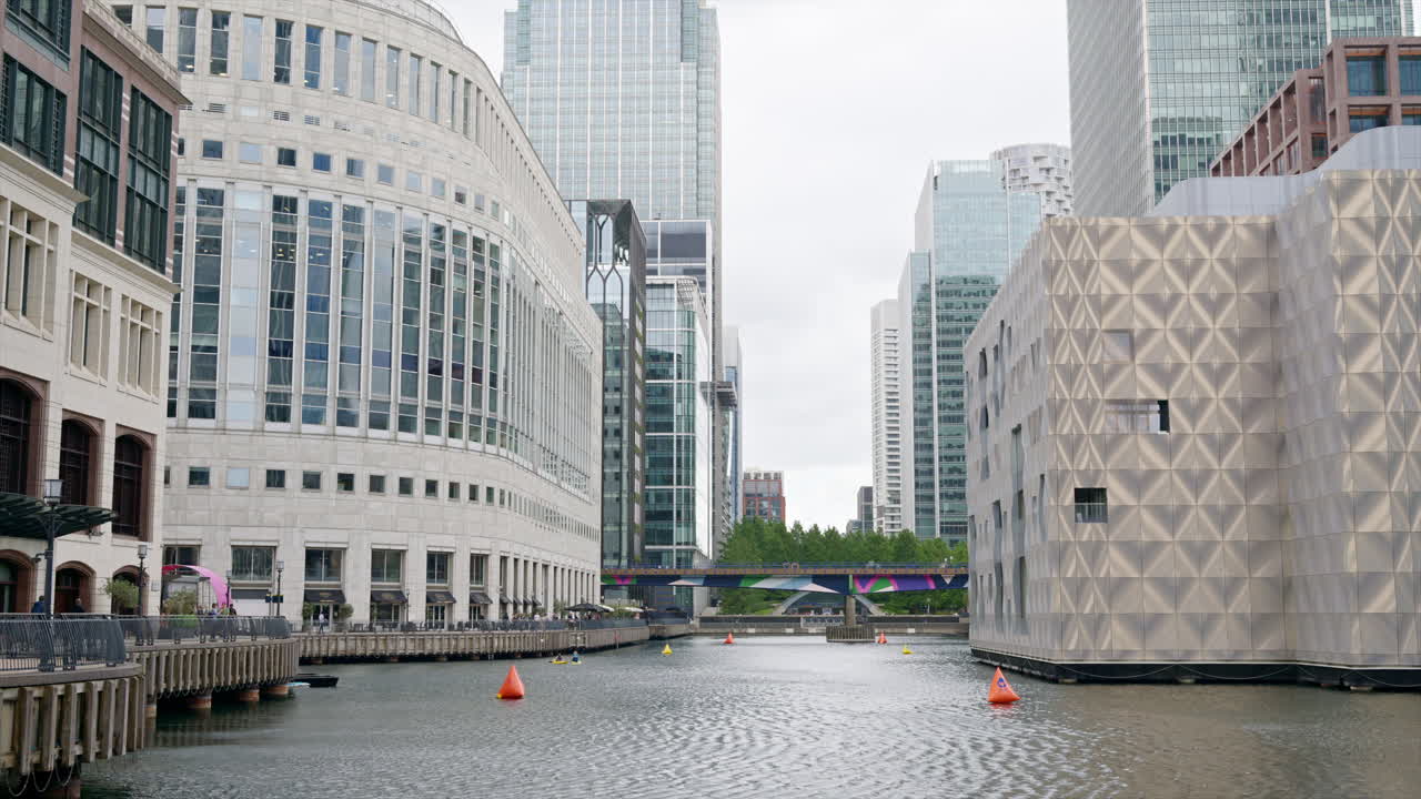 Street scape of the Canary Wharf district, water channels with modern buildings and skyscrapers around in London, United Kingdom