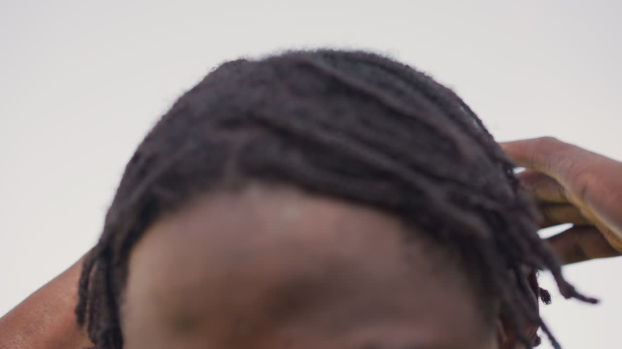 Focused Mental Alertness, Concentrated Gesture With Braided Hair, Signaling Readiness Through Forehead Gesture And Tense Gaze, Expressing Intense Focus With Braided Hair And Steadfast Breath Control