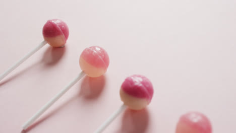 video of pink lollipops on pink background