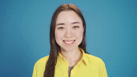 Smiling-young-Asian-woman-looking-at-camera-fun-and-happy.