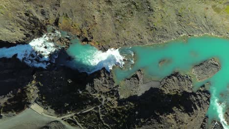 turquoise blue water of paine river waterfall in torres del paine national park, chile, top down aerial