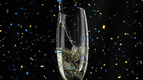 Animation-of-confetti-over-glass-of-champagne