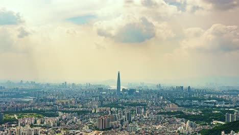 a stunning zoom-in timelapse captures moving clouds and dramatic light over the sprawling metropolis of seoul, focusing on the iconic lotte world tower, as viewed from namhansanseong fortress