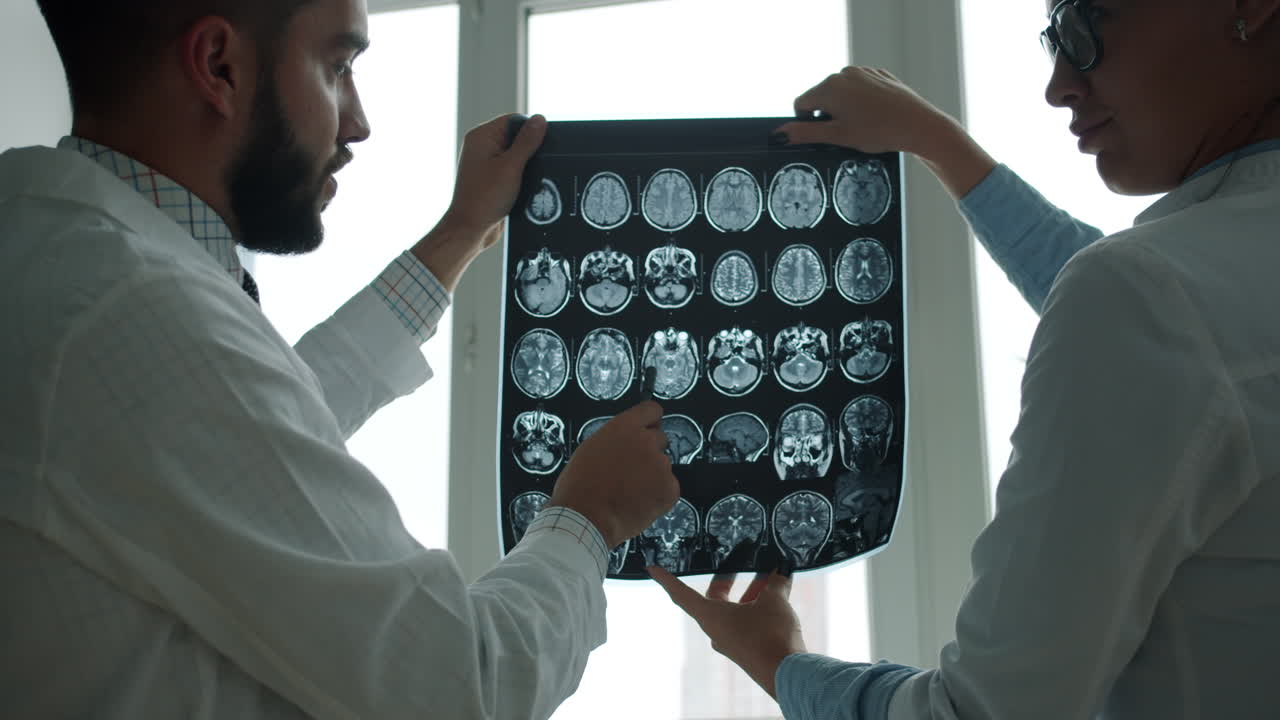 Doctors Reviewing Brain MRI Scans