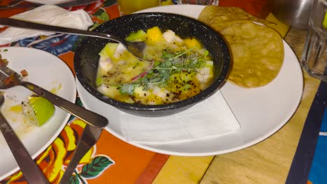 close-up of fresh mexican dish with avocado, herbs and spices served with tortillas, healthy and delicious meal