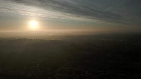 sun above misty landscape aerial warwickshire uk