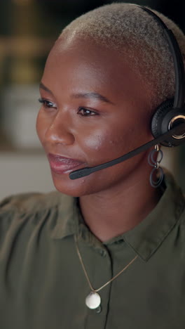 portrait of a smiling woman wearing a headset, working in a call center