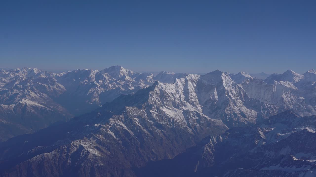 Aircraft view of Nepal Himalayas showing mountain range, cloud formations, and breathtaking natural environment from above