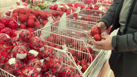 man shopping for christmas ornaments