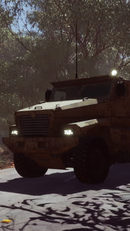 armored military vehicle driving through a desert landscape