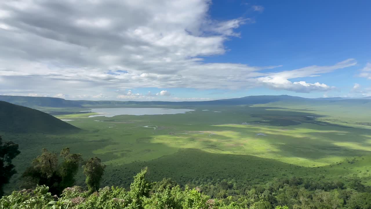 Panoramic view of Ngorongoro Crater from the viewing platform on a sunny day. Tanzania.