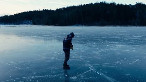 indre fosen, trondelag county, norway - a person walking on the snow-covered expanse of omundvatnet - orbit drone shot