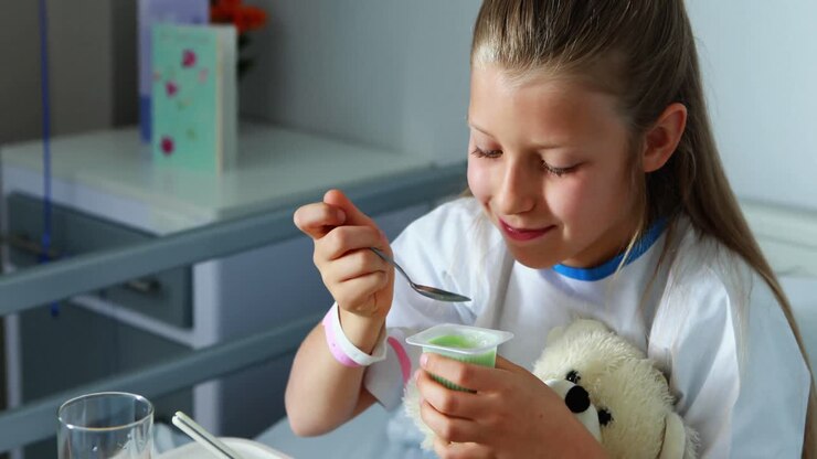 Sick girl having food on bed