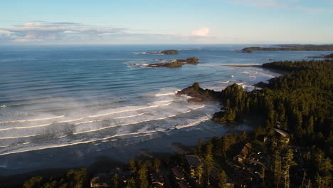 panoramic aerial view of foamy waves from the pacific ocean in tofino on vancouver island, bc canada