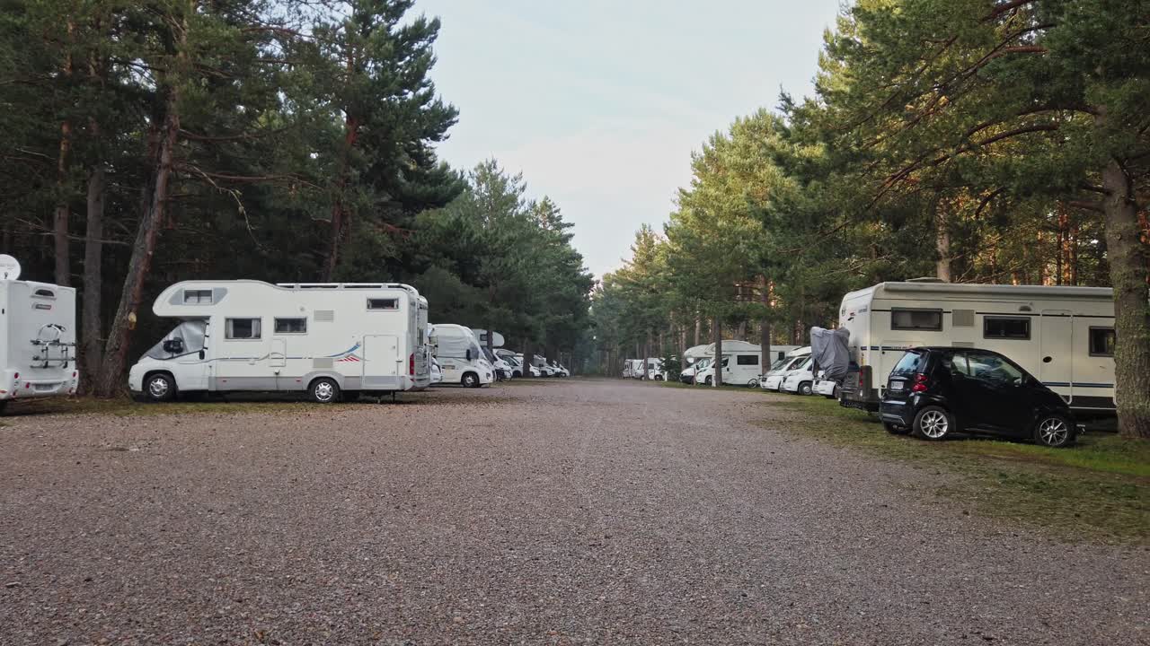 Motor homes parked at camping car park, Matemale Park, France. Pan right