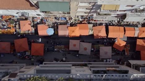 aerial drone shot twisting over urban street market exarcheia athens greece