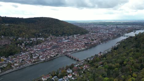 high wide angle drone shot of heidelberg, shot from above autumn forest