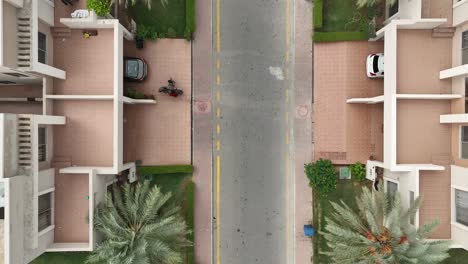 A-street-view-and-roofs-of-the-houses-from-the-top-as-car-passes-by-the-houses---lifestyle-in-Pakistan