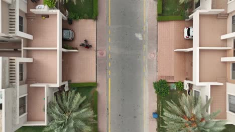 a street view and roofs of the houses from the top as car passes by the houses - lifestyle in pakistan