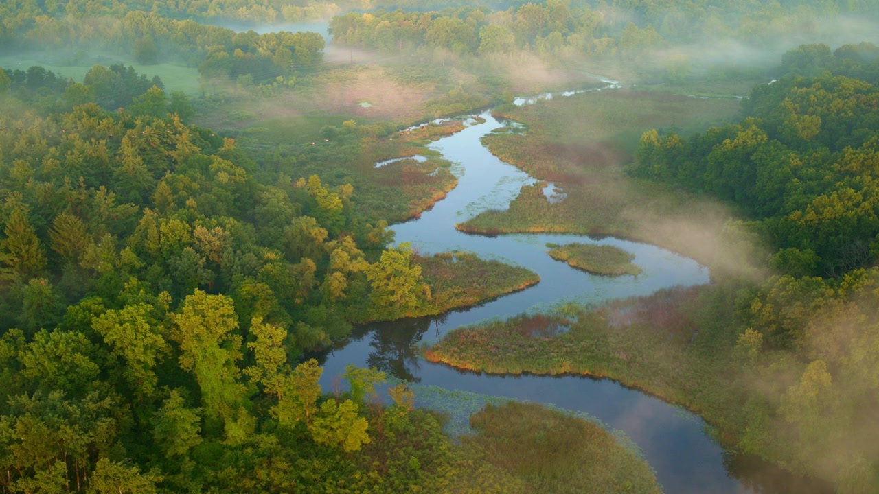 Milford, Michigan's Huron River at dawn, veiled in mist and captured by a drone.