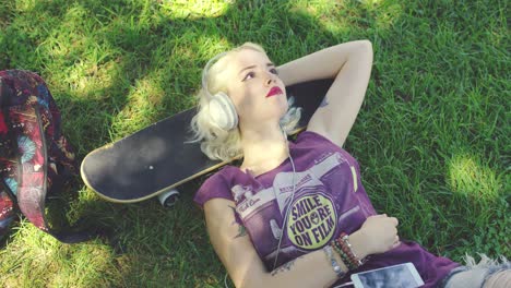 young blond woman relaxing listening to music