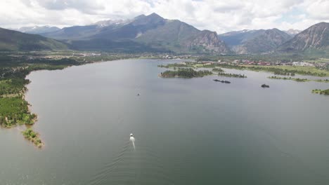 aerial footage of dillon reservoir near breckenridge colorado, you can see a boat on the water and mountains in the background