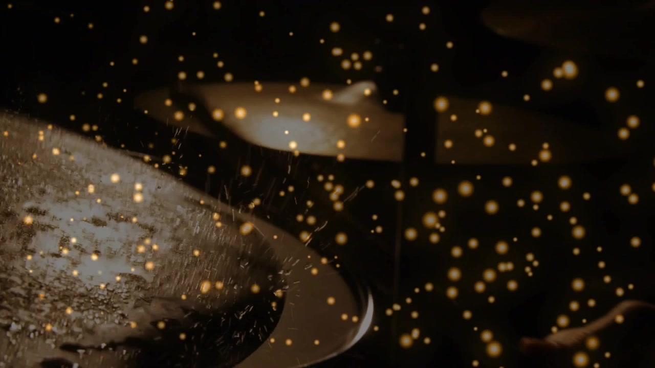 Luce dinamica della telecamera che accarezza cucchiai di metallo, con goccioline scintillanti e bokeh dorato che fluttua sui bordi, per annunci pubblicitari