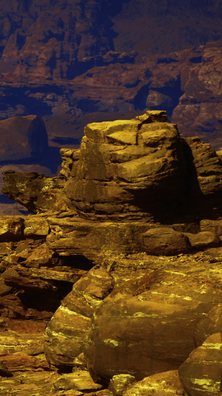 Rock formations in a canyon at dusk with layered textures and colors