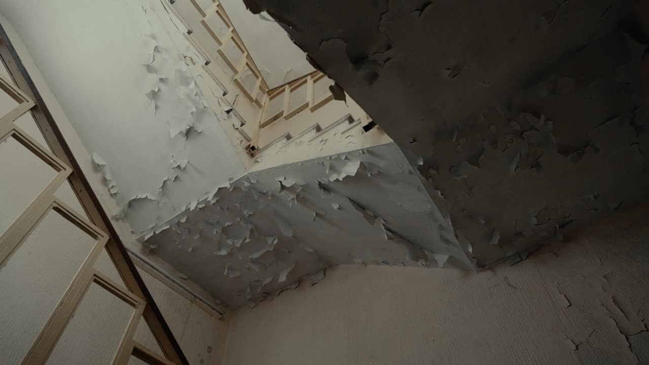 Interno in rovina con pittura scrostata su pareti e soffitto