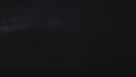 flashes of lightning light up the nighttime sky in fast motion clip