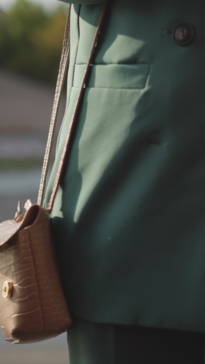Busy woman approaches bright red car holding mobile phone. Young female driver takes out car key with fobs preparing to go on business closeup